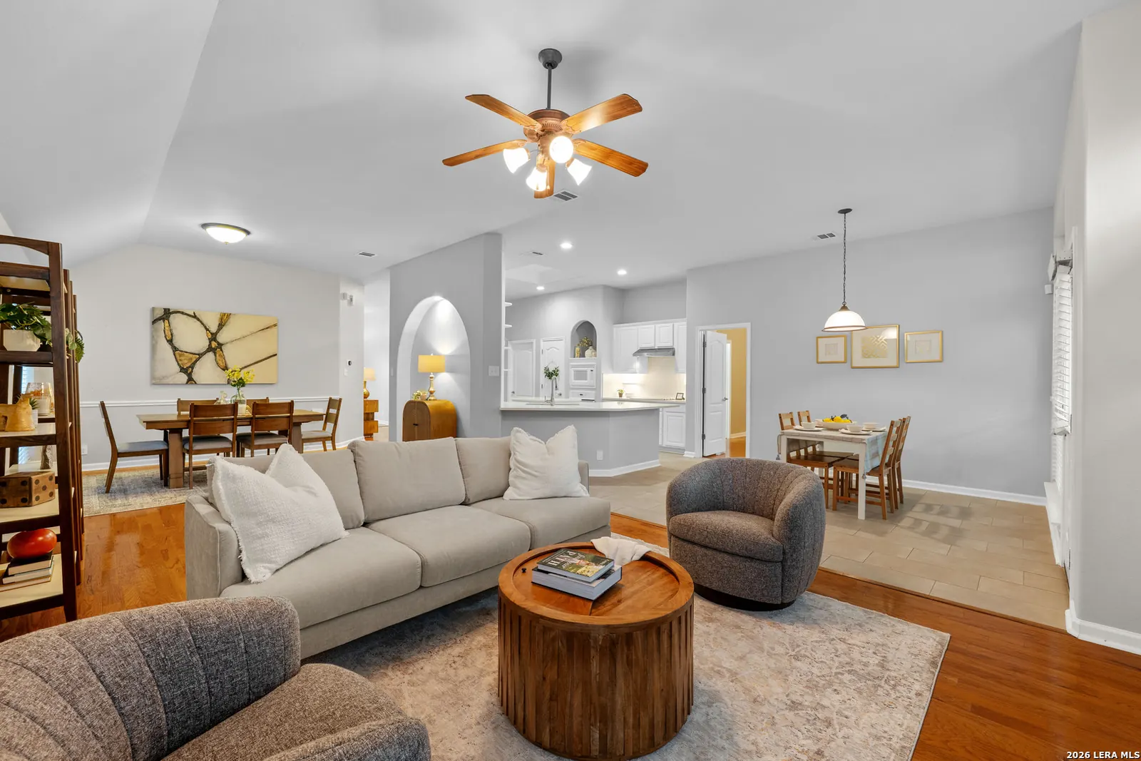 Staged living and dining space with fireplace and warm seating